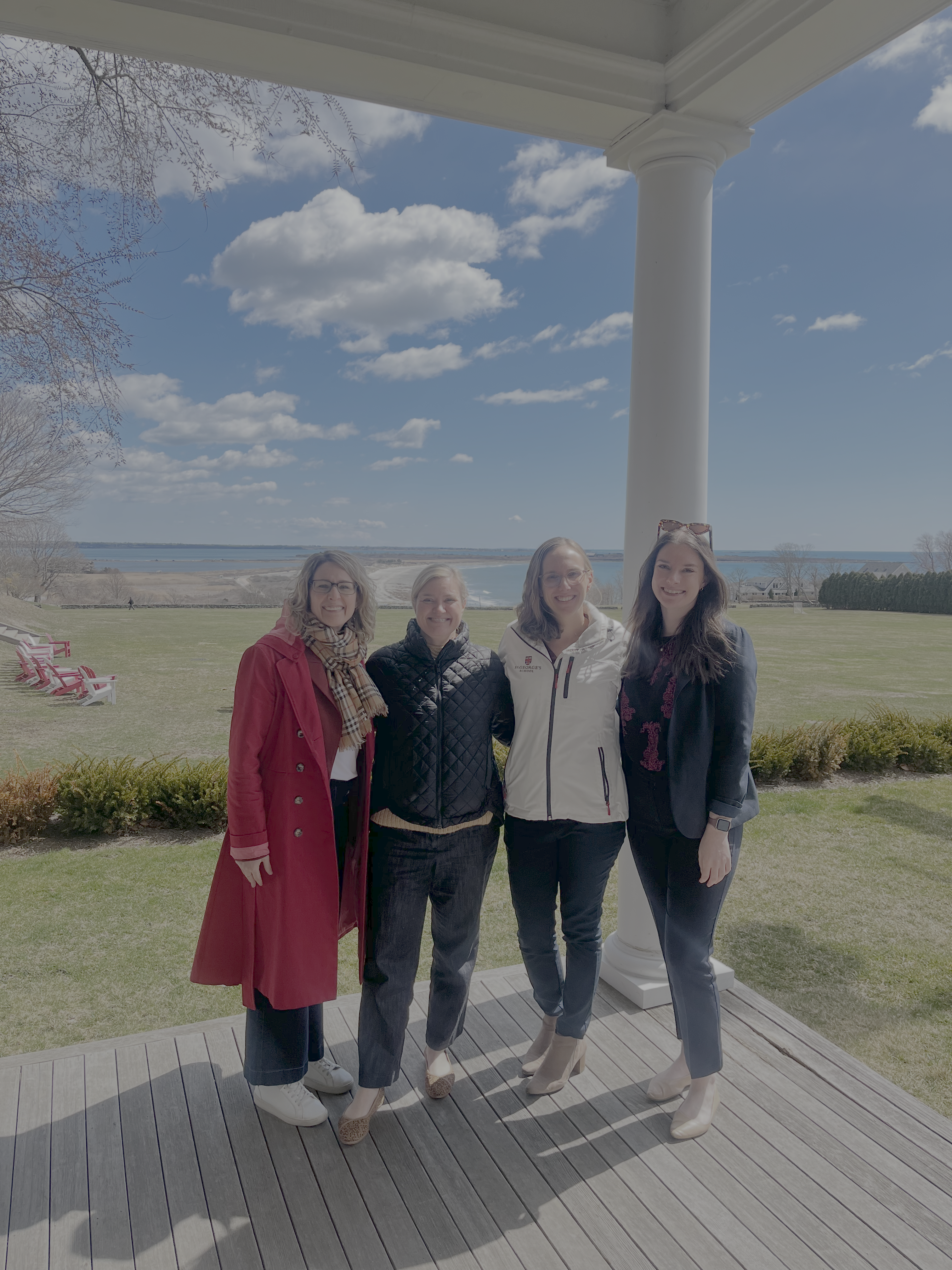 Four women in front of the ocean